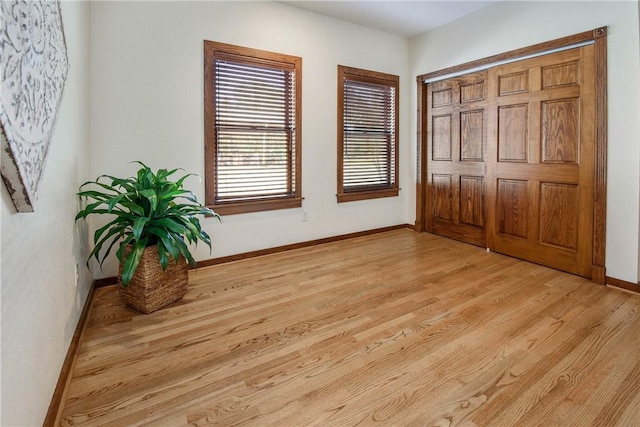 bedroom with a closet and light hardwood / wood-style flooring