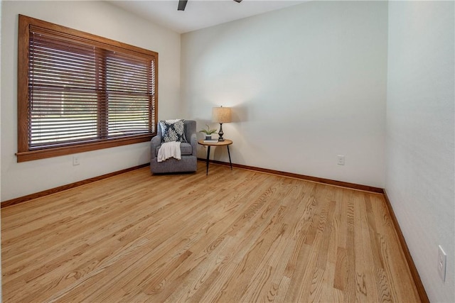 living area featuring ceiling fan and light hardwood / wood-style flooring