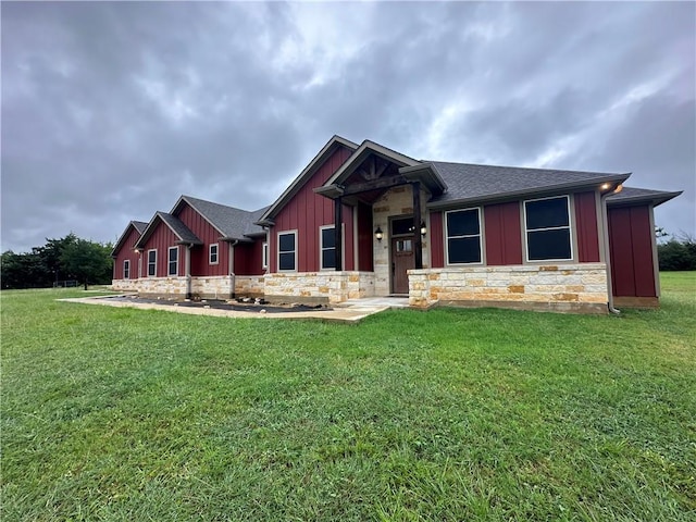 114 Hayes Church Rd, Franklin, TX 77856 - view of front facade featuring stone siding, board and batten siding, a front lawn, and a shingled roof