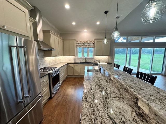 114 Hayes Church Rd, Franklin, TX 77856 - kitchen featuring appliances with stainless steel finishes, wall chimney range hood, ornamental molding, dark wood-style flooring, and dark stone countertops