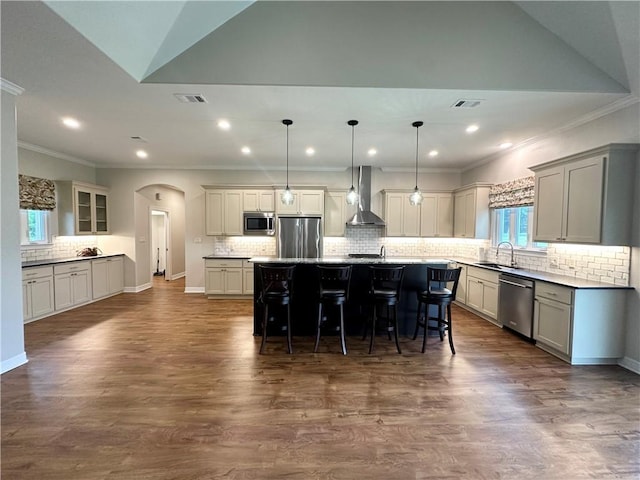 114 Hayes Church Rd, Franklin, TX 77856 - kitchen with stainless steel appliances, wall chimney exhaust hood, ornamental molding, decorative backsplash, and a kitchen bar
