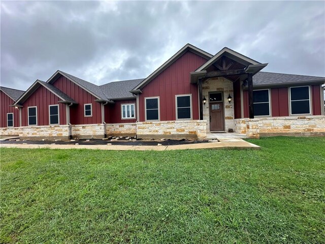 114 Hayes Church Rd, Franklin, TX 77856 - view of front of property with stone siding, board and batten siding, a front lawn, and roof with shingles