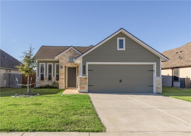 view of front of home with central AC, a front lawn, and a garage