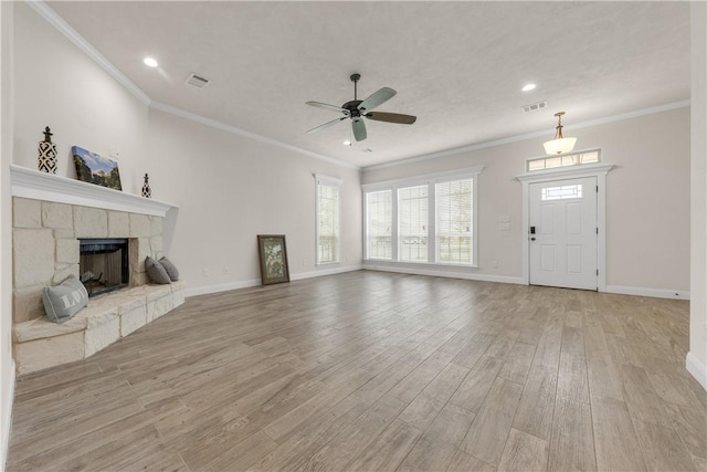 unfurnished living room featuring a fireplace, ceiling fan, light hardwood / wood-style floors, and crown molding