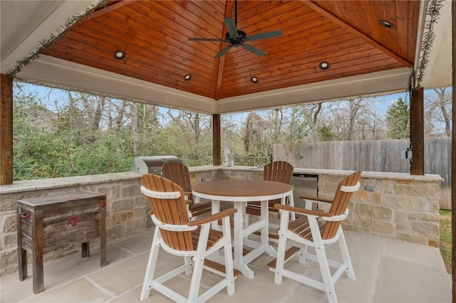 sunroom / solarium with lofted ceiling and ceiling fan