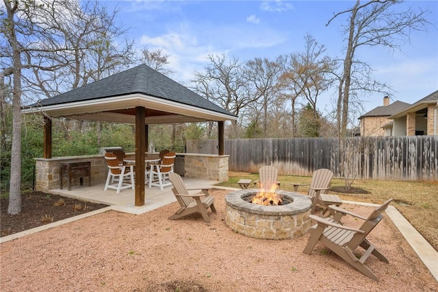 view of patio featuring a gazebo, an outdoor fire pit, and fence