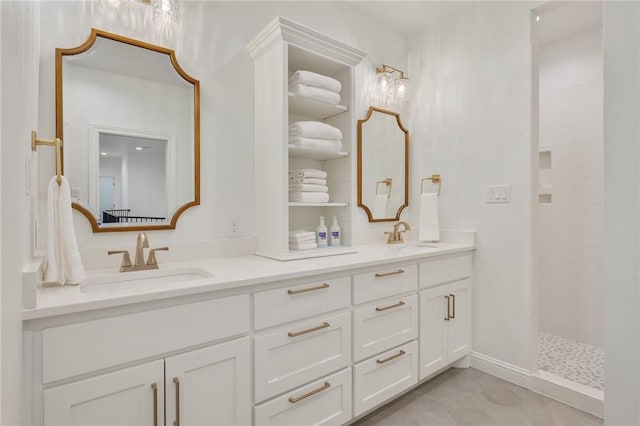 bathroom featuring double vanity, walk in shower, and a sink