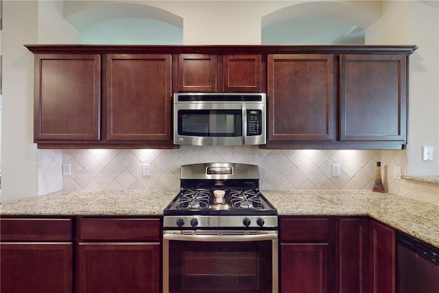 2515 Warkworth Ln, College Station, TX 77845 - kitchen with appliances with stainless steel finishes, backsplash, light stone counters, and dark brown cabinets