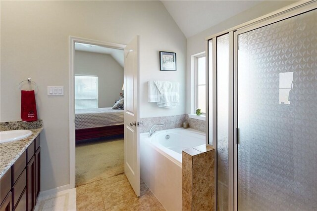 2515 Warkworth Ln, College Station, TX 77845 - ensuite bathroom featuring healthy amount of natural light, lofted ceiling, vanity, a bath, and a shower stall