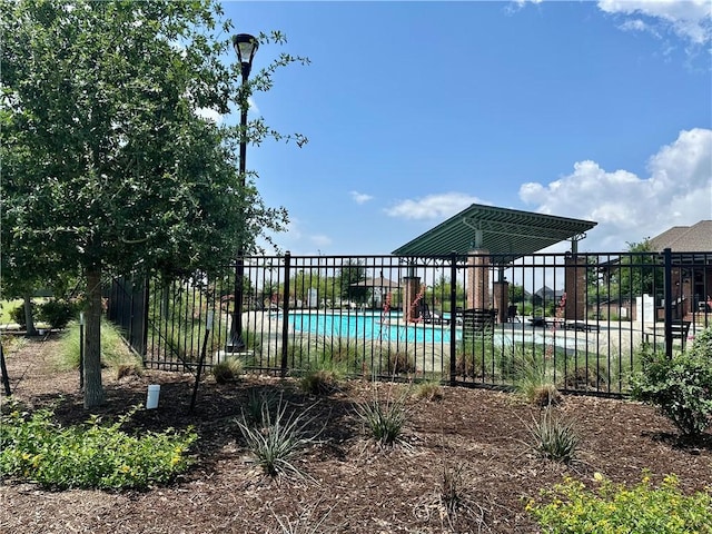 view of gate featuring a community pool and fence