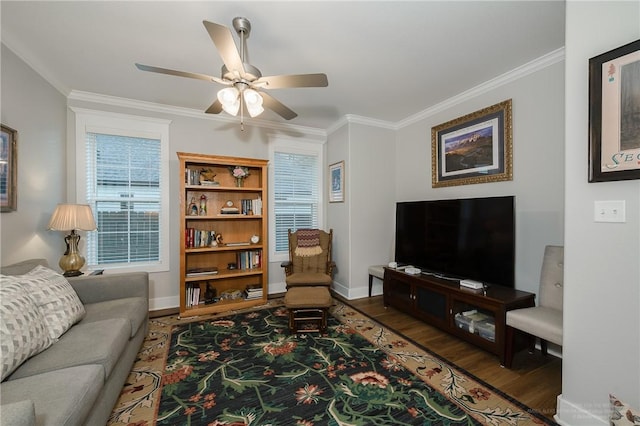 living room with crown molding, ceiling fan, baseboards, and wood finished floors