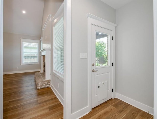 5012 Grayson Way, Bryan, TX 77802 - entryway with wood finished floors and a brick fireplace