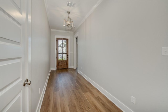 5012 Grayson Way, Bryan, TX 77802 - doorway to outside featuring a chandelier, ornamental molding, and wood finished floors