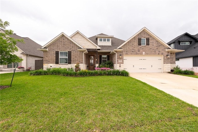 craftsman-style home featuring roof with shingles, stone siding, brick siding, a front yard, and concrete driveway