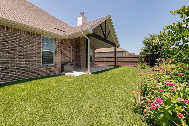 5012 Grayson Way, Bryan, TX 77802 - rear view of property with brick siding, a patio area, roof with shingles, and a chimney