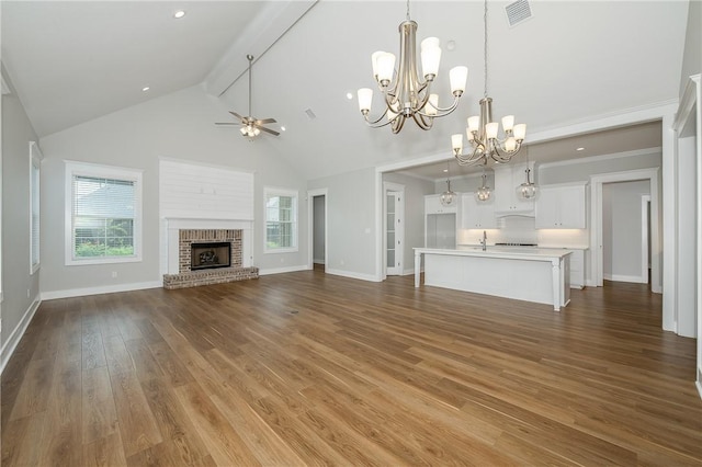 5012 Grayson Way, Bryan, TX 77802 - unfurnished living room featuring high vaulted ceiling, a ceiling fan, a chandelier, a brick fireplace, and beam ceiling
