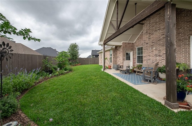 view of yard with a fenced backyard and a patio