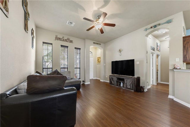 living room featuring dark hardwood / wood-style floors and ceiling fan