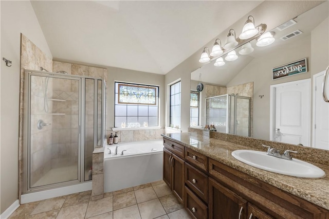 bathroom with tile patterned floors, vanity, vaulted ceiling, and independent shower and bath