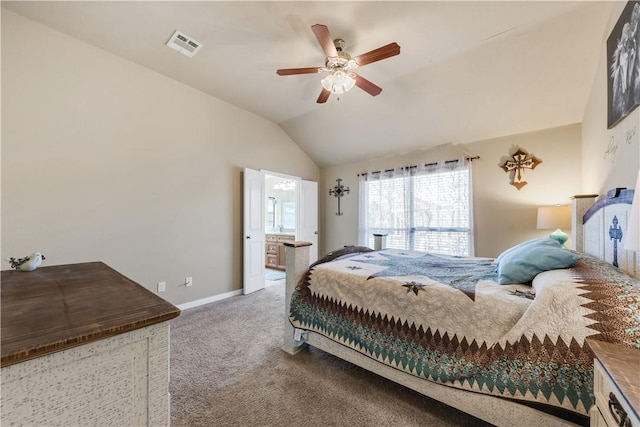 carpeted bedroom featuring ceiling fan, ensuite bathroom, and vaulted ceiling