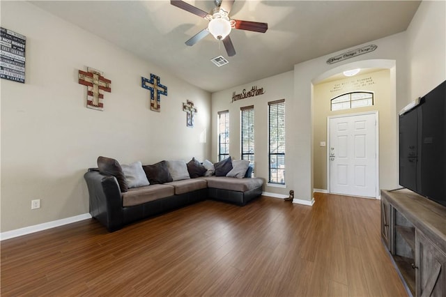 living room with dark hardwood / wood-style floors and ceiling fan