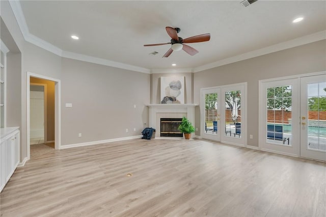 4213 Bedford Ct, Bryan, TX 77802 - unfurnished living room with french doors, crown molding, light wood-style flooring, ceiling fan, and a fireplace with flush hearth