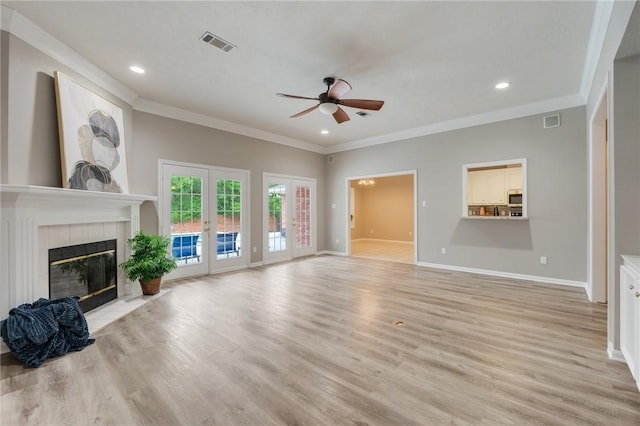 4213 Bedford Ct, Bryan, TX 77802 - unfurnished living room with ceiling fan, crown molding, light wood-style floors, a tile fireplace, and recessed lighting