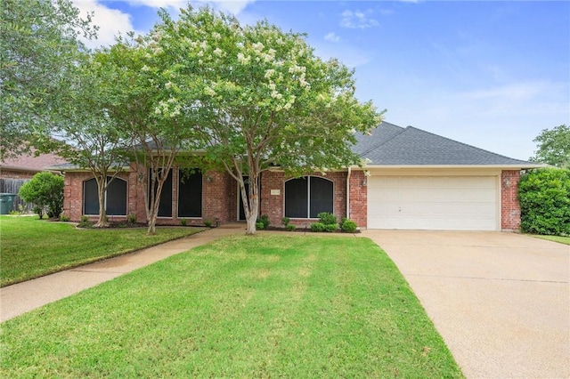 4213 Bedford Ct, Bryan, TX 77802 - view of front of property featuring an attached garage, driveway, a front lawn, and brick siding