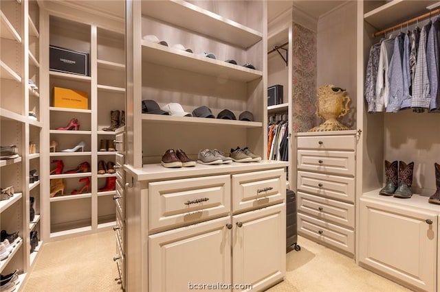 walk in closet featuring light carpet