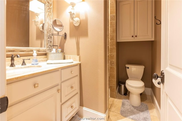 bathroom with tile patterned floors, vanity, and toilet