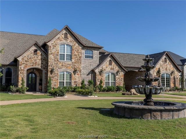 french provincial home with a front lawn