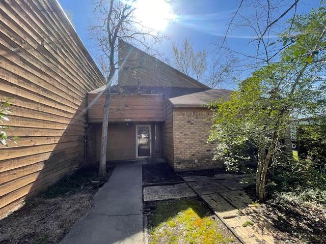 property entrance featuring brick siding