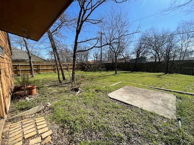 view of yard with a fenced backyard and a patio area