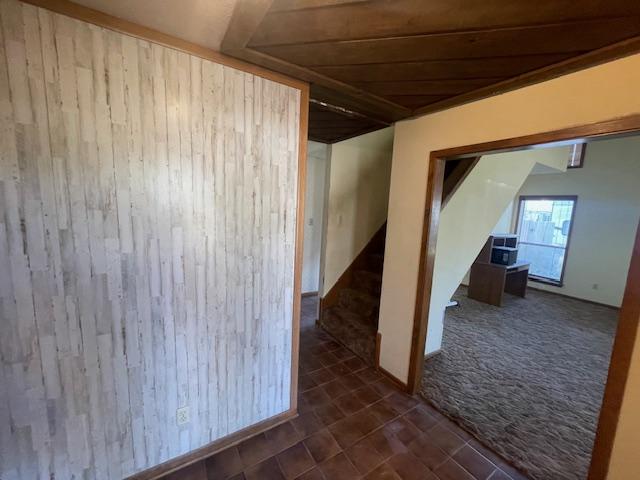 empty room featuring dark colored carpet