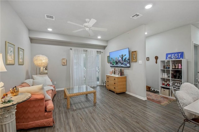 living room with recessed lighting, visible vents, baseboards, and wood finished floors