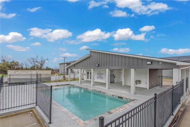 community pool featuring a patio and fence