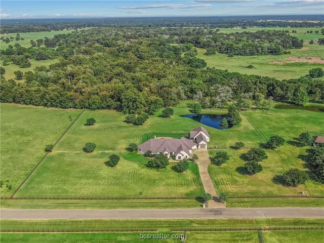 birds eye view of property featuring a rural view and a water view