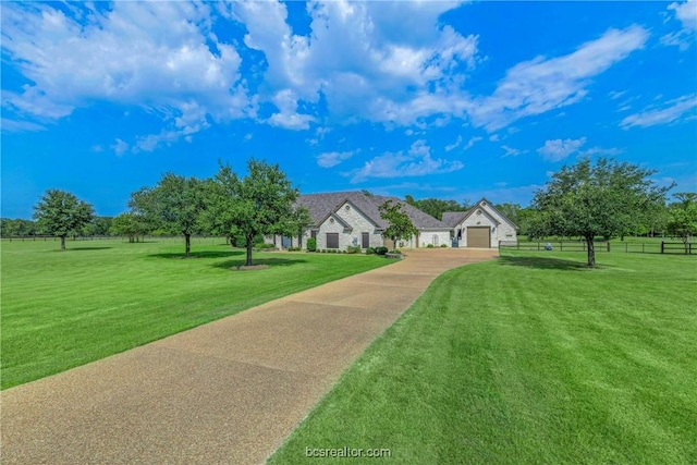 view of front of home with a front yard and a garage