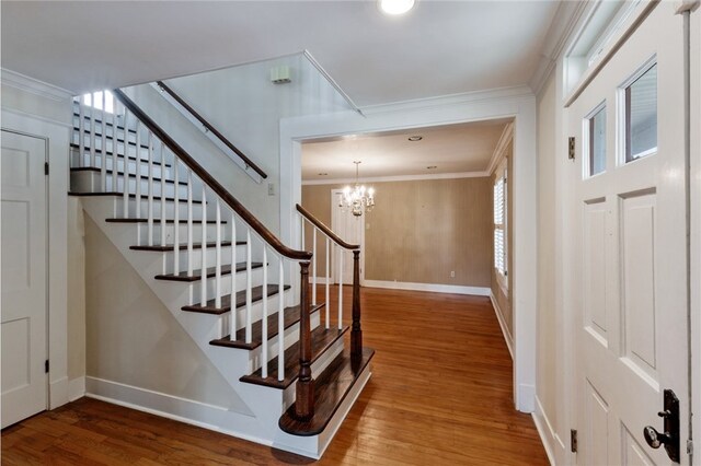 1712 Glade St, College Station, TX 77840 - stairway featuring wood finished floors, crown molding, and a chandelier