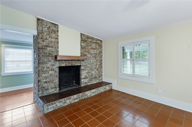 1712 Glade St, College Station, TX 77840 - unfurnished living room with crown molding, dark tile patterned floors, a brick fireplace, and lofted ceiling
