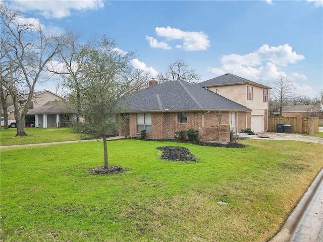 view of front of property featuring a garage and a front yard