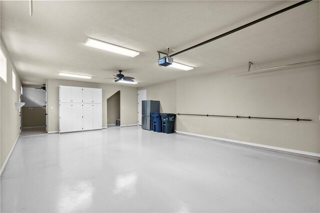 5104 Stonewater Loop, College Station, TX 77845 - garage featuring a garage door opener and freestanding refrigerator
