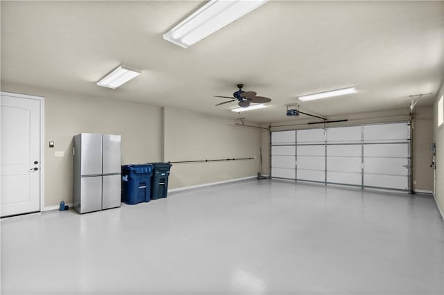 5104 Stonewater Loop, College Station, TX 77845 - garage with a garage door opener, ceiling fan, and freestanding refrigerator