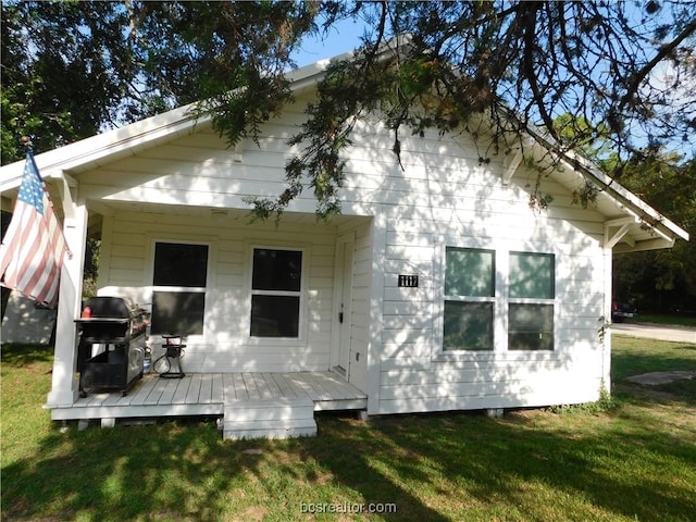 1117 Sycamore St, Navasota, TX 77868 - rear view of house featuring a wooden deck and a yard