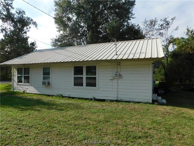 1117 Sycamore St, Navasota, TX 77868 - rear view of property with metal roof and a lawn