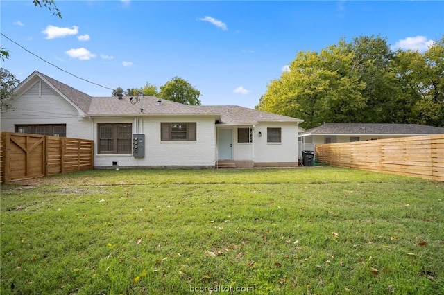 rear view of property with a lawn