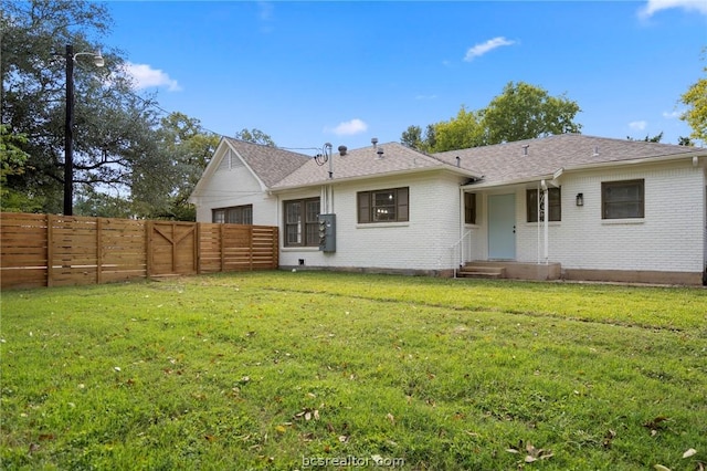 back of house with a lawn