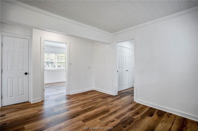 unfurnished room with crown molding and dark wood-type flooring