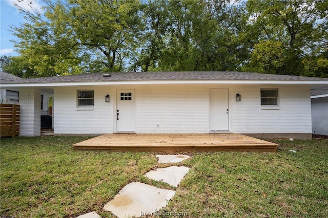 back of house featuring a deck and a yard