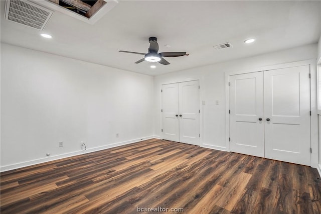 unfurnished bedroom featuring dark hardwood / wood-style floors and ceiling fan